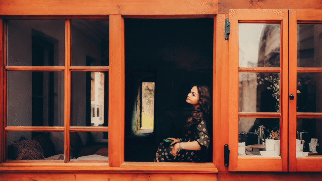 a woman sitting in a window