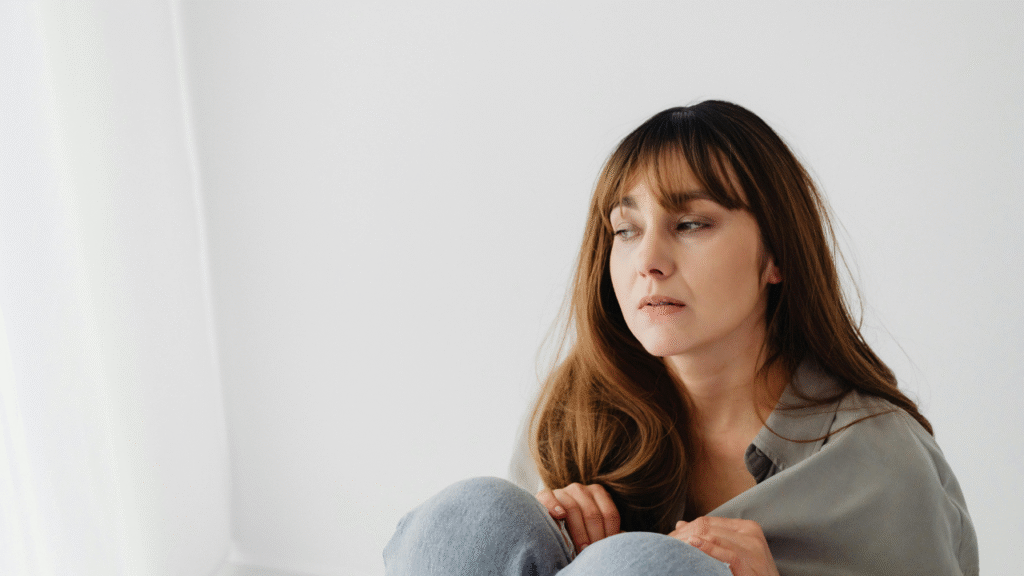 Person sitting quietly with eyes closed as part of a daily routine