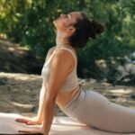 A calm person practicing belly breathing with one hand on their chest and the other on their stomach, focusing on slow, deep breaths.