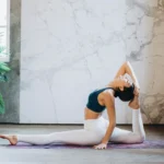 Person practicing Embodied Yoga with mindful breathing and gentle movement in a peaceful studio