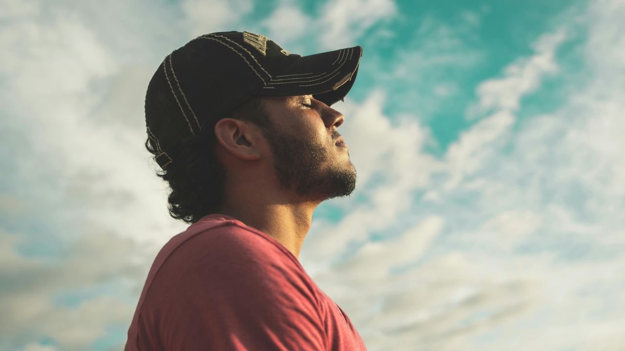 A calm person meditating peacefully in nature, showing mindfulness and awareness, in contrast to a shadowy figure symbolizing emotional disconnection and dissociation.